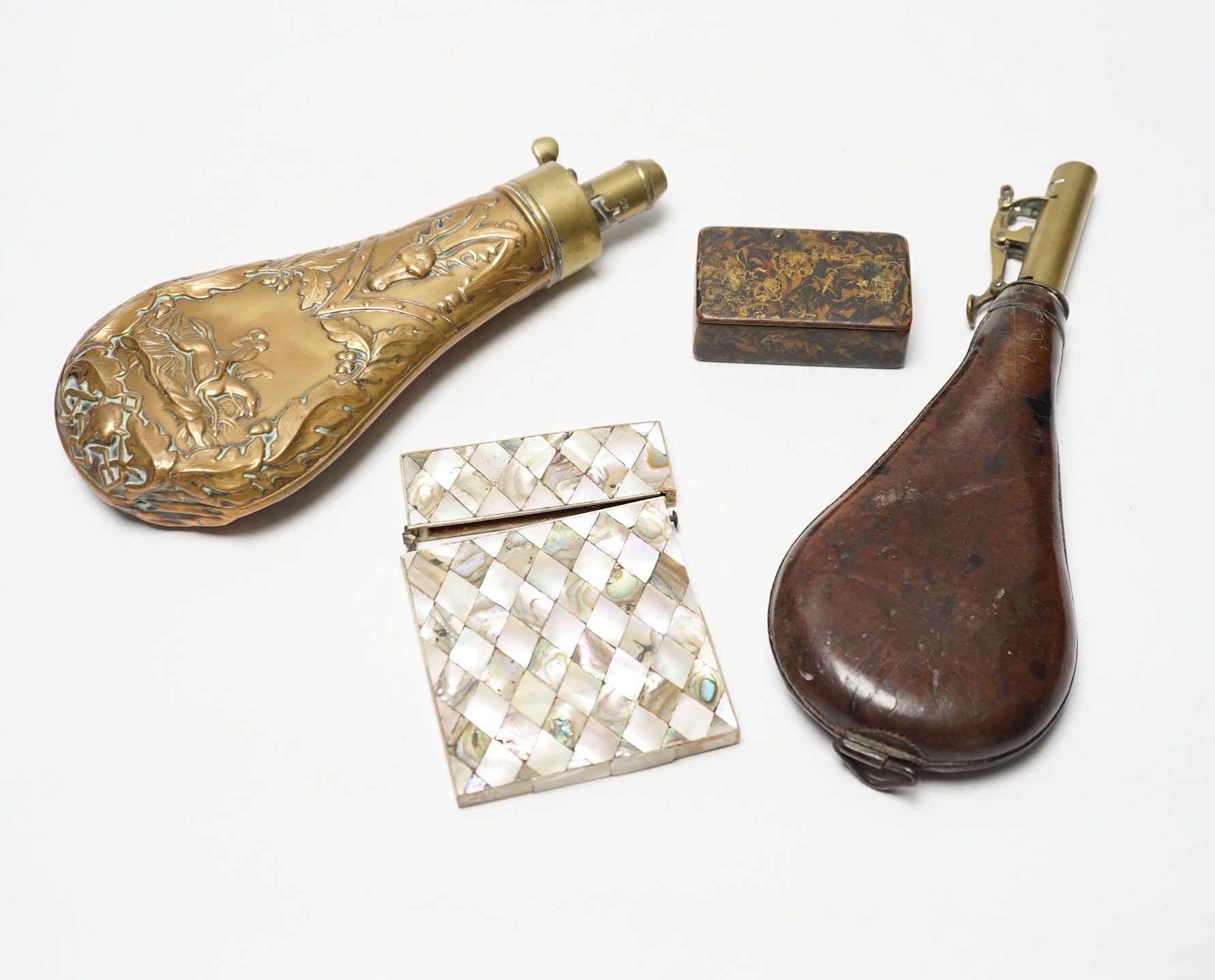 A Victorian embossed brass powder flask, a leather shot flask and a Victorian mother of pearl and abalone calling card case